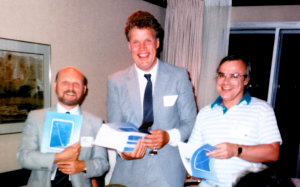 Image of three men standing and smiling at the camera. On the left is Alan Blizzard, in the middel is Greg Snow and on the right is Dale Roy.